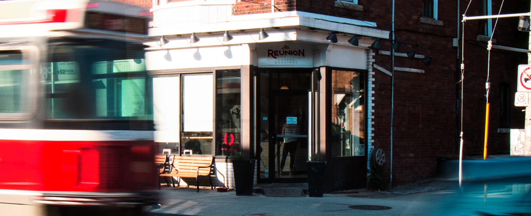 Image of Reunion Coffee Café in Toronto with red streetcar in front. 